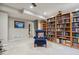 Living room with built-in bookshelves and comfortable arm chair at 15079 E Poundstone Pl, Aurora, CO 80015