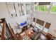 Bright living room with vaulted ceilings, a modern chandelier, fireplace, custom shelving, and large windows at 15079 E Poundstone Pl, Aurora, CO 80015