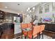 Open concept living room with a modern chandelier, staircase, and a view into the kitchen at 15079 E Poundstone Pl, Aurora, CO 80015