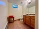 Bathroom with tiled floor, toilet, wood vanity, and small window for natural light at 3240 Folsom St, Boulder, CO 80304