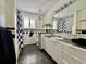 Updated bathroom featuring black-and-white tile, modern vanity, and a stylish shower curtain at 3240 Folsom St, Boulder, CO 80304