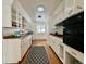 Bright kitchen featuring white cabinetry, stainless appliances, wood countertops and patterned rug at 3240 Folsom St, Boulder, CO 80304