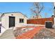 The backyard features a detached garage, wood fence and a walkway to the main house at 1724 W 40Th Ave, Denver, CO 80211