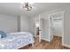 Bedroom with ceiling fan and open doors to a closet and open stairs at 1724 W 40Th Ave, Denver, CO 80211