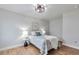 Cozy bedroom featuring wood floors, ceiling fan and two side tables with decorative lamps at 1724 W 40Th Ave, Denver, CO 80211