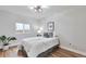 Well lit bedroom with hardwood floors, ceiling fan, window and a full size bed at 1724 W 40Th Ave, Denver, CO 80211