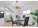 Dining room featuring a modern chandelier, hardwood floors, and seating for four at 1724 W 40Th Ave, Denver, CO 80211