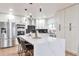 Bright kitchen features white cabinets, stainless steel appliances, and a large island with bar seating at 1724 W 40Th Ave, Denver, CO 80211