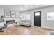 Cozy living room with a decorative fireplace, hardwood floors, and modern decor at 1724 W 40Th Ave, Denver, CO 80211