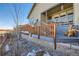 Back deck area with a retaining wall, decorative trees, and steps to the upper portion at 4051 Happy Hollow Dr, Castle Rock, CO 80104