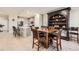 Open-concept dining area with kitchen in the background, featuring a stylish hutch and chairs at 4051 Happy Hollow Dr, Castle Rock, CO 80104