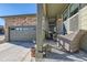 Inviting front porch with seating, a decorative bear statue, and a view of the attached garage at 4051 Happy Hollow Dr, Castle Rock, CO 80104