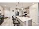 Modern kitchen featuring a large center island, pendant lighting, and ample counter space at 4051 Happy Hollow Dr, Castle Rock, CO 80104