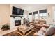 Cozy living room featuring a fireplace, plush seating, large windows, and neutral decor at 4051 Happy Hollow Dr, Castle Rock, CO 80104