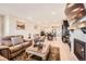 Spacious living area with modern fireplace and décor seamlessly connecting to dining and kitchen spaces at 4051 Happy Hollow Dr, Castle Rock, CO 80104