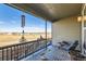 Relaxing patio with a beautiful view, featuring a cozy wicker chair and outdoor table at 4051 Happy Hollow Dr, Castle Rock, CO 80104