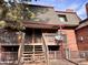 Brick building exterior with wooden stairs and a deck at 5491 E Warren Ave # 217, Denver, CO 80222