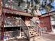 Brick building exterior with wooden stairs and a deck at 5491 E Warren Ave # 217, Denver, CO 80222