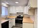 Galley kitchen with stainless steel appliances and white cabinets at 5491 E Warren Ave # 217, Denver, CO 80222