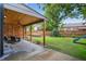 Large backyard with a well-maintained lawn, trampoline, slide, and a covered patio, perfect for outdoor activities at 4333 E Bennington Ave, Castle Rock, CO 80104