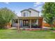 Charming two-story home with a covered patio, outdoor seating, and a well-manicured backyard at 4333 E Bennington Ave, Castle Rock, CO 80104