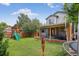 Backyard with a covered patio, outdoor seating, trampoline, play structure and a well-manicured lawn at 4333 E Bennington Ave, Castle Rock, CO 80104