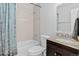 Bathroom showcasing a tub shower, tiled walls, dark vanity, and granite countertop at 4333 E Bennington Ave, Castle Rock, CO 80104