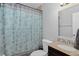 Bathroom featuring a granite vanity, modern fixtures, and a paisley patterned shower curtain at 4333 E Bennington Ave, Castle Rock, CO 80104