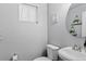 Neutral powder room with stylish decor, round mirror, and toilet at 4333 E Bennington Ave, Castle Rock, CO 80104