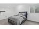 This cozy bedroom is carpeted and has natural light from the window above the comfortable bed at 4333 E Bennington Ave, Castle Rock, CO 80104