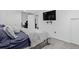 Spacious bedroom with gray carpet, ample lighting, tv and a comfortable queen bed at 4333 E Bennington Ave, Castle Rock, CO 80104