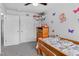 Bright bedroom with a comfortable bed, gray carpet and a whimsical display of decorations and toys at 4333 E Bennington Ave, Castle Rock, CO 80104