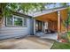Exterior view of the home showcasing a covered patio area with outdoor seating and a well-kept lawn at 4333 E Bennington Ave, Castle Rock, CO 80104