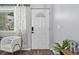 Bright foyer with decorative front door, chair, and hardwood floors at 4333 E Bennington Ave, Castle Rock, CO 80104
