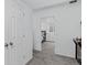 Hallway view into carpeted basement bedroom with recessed window and gray queen bed at 4333 E Bennington Ave, Castle Rock, CO 80104