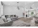 Open concept living room featuring hardwood floors, fireplace and a gray sofa at 4333 E Bennington Ave, Castle Rock, CO 80104