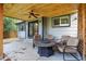 Inviting covered patio features a ceiling fan, comfortable seating around a fire pit, and easy access to the home at 4333 E Bennington Ave, Castle Rock, CO 80104