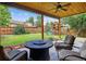 Covered patio with wood ceiling, fan, outdoor seating, and a backyard play structure at 4333 E Bennington Ave, Castle Rock, CO 80104