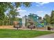 Community playground with colorful play structures, climbing walls, slides, and cushioned ground for ' safety at 4333 E Bennington Ave, Castle Rock, CO 80104