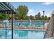 Community swimming pool featuring multiple lanes, ample seating, and a clear blue water on a sunny day at 4333 E Bennington Ave, Castle Rock, CO 80104