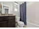 bathroom with tub shower combo and granite countertop at 10350 E 57Th Pl, Denver, CO 80238