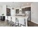 Modern kitchen with dark cabinets and a large island at 10350 E 57Th Pl, Denver, CO 80238