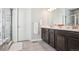 Elegant main bath with double vanity, large shower, and tile at 10350 E 57Th Pl, Denver, CO 80238