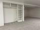 Finished basement space featuring built-in shelving and neutral carpeting at 16289 E Wagontrail Dr, Aurora, CO 80015