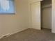 Bedroom featuring neutral carpeting, a window with blinds, and closet with sliding door at 16289 E Wagontrail Dr, Aurora, CO 80015