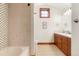 Bright bathroom features wooden vanity, a neutral color palette, and shower and tub at 651 Ruby Trust Dr, Castle Rock, CO 80108