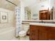 Bathroom featuring a shower-tub combo with mosaic tile and a wooden vanity at 651 Ruby Trust Dr, Castle Rock, CO 80108