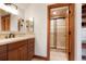 Bathroom featuring wooden vanity, a large mirror, and a shower room at 651 Ruby Trust Dr, Castle Rock, CO 80108