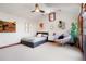 Well-lit bedroom with a cozy sitting area, neutral decor, and warm lighting at 651 Ruby Trust Dr, Castle Rock, CO 80108