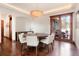 Dining area with chandelier lighting, wooden table, and sliding doors at 651 Ruby Trust Dr, Castle Rock, CO 80108